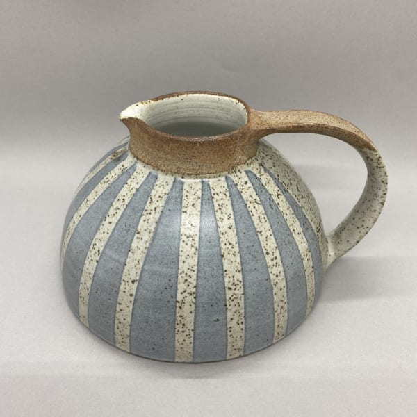 Kate Garwood jug in a squat, round shape with a pale blue body and white vertical stripes