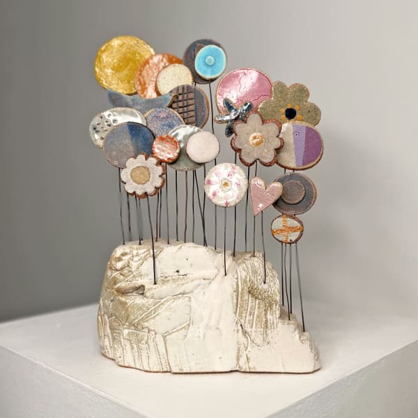 Jane Muir ceramic sculpture of a boulder with wire ceramic multi-coloured flowers springing out of it