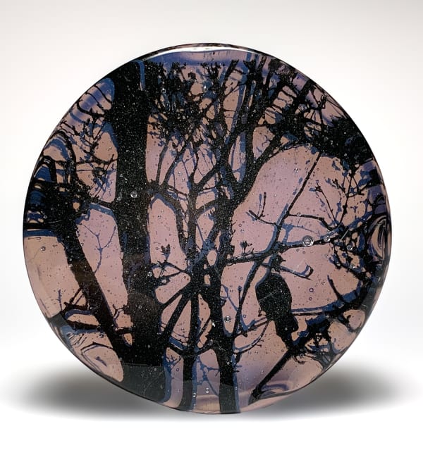 Helen Slater glass sculpture a black drawing of a dove in tree branches is set within plum coloured glass