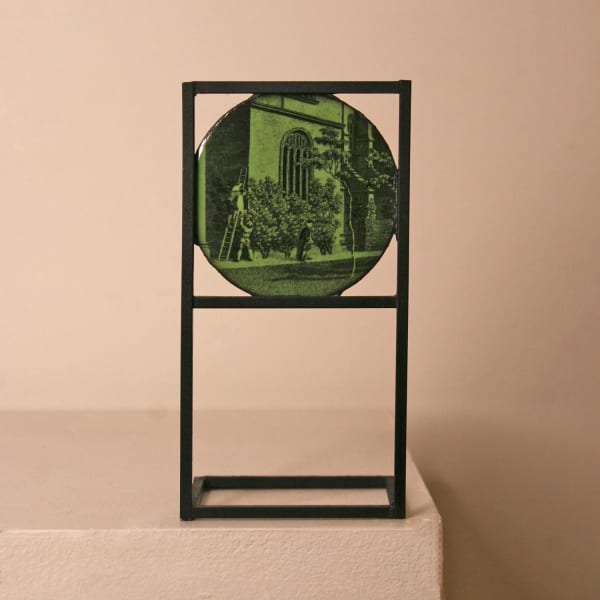 David Rhys Jones vitreous enamel and stainless steel sculpture with etching imagery of a gardener in the quad of an Oxford college