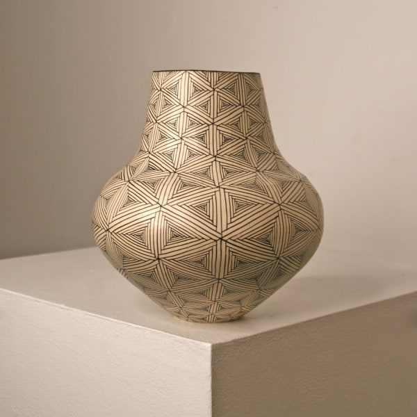 Tydd Pottery extra small vessel with a rounded bottom and longer neck hand painted geometrical flag patterns