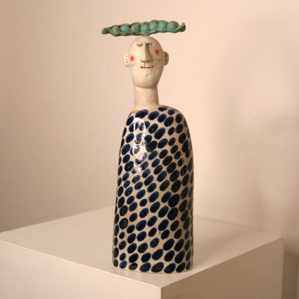 Jane Muir minimalist sculpture of a man with a pea pod resting on his head, with blue spots