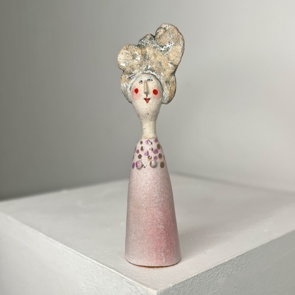 Jane Muir ceramic sculpture of little lady with baby pink glaze and lilac dots