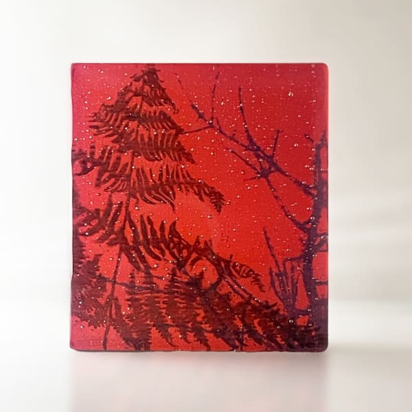 Helen Slater glass sculpture with black drawing of fern in coral and opaline glass