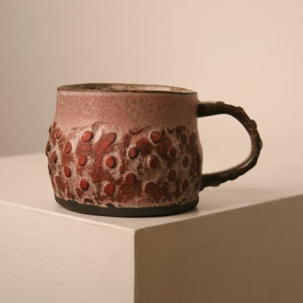 Elly Wall stoneware ceramic mug with raised bumped texture and red glaze