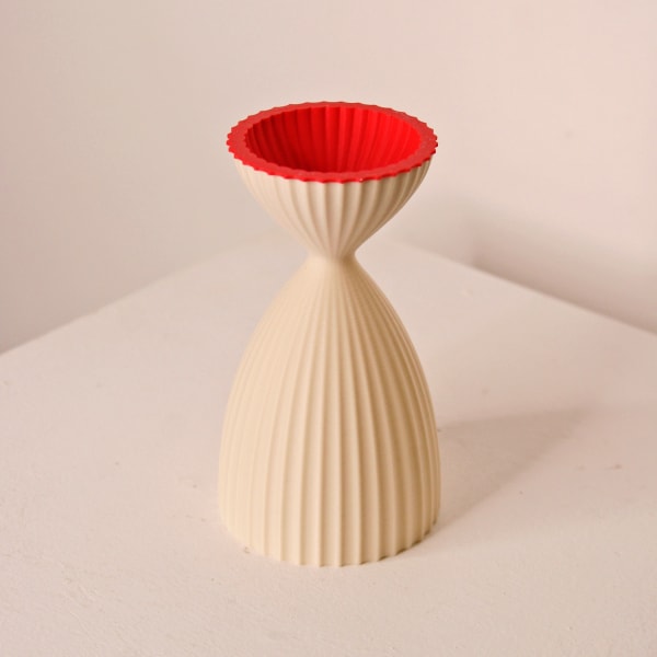 Keeley Traae 3d printed PLA vase in a pinched curve shape and dimensional zig-zagged texture, milk and red