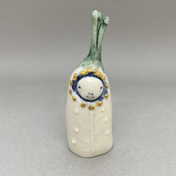 Marina Bauguil tiny sculpture of a plant spirit with a hat in the shape of a green sprout.