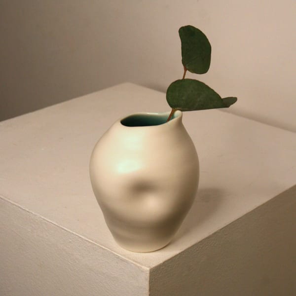 Linda Bloomfield ceramic oval shaped jug with dimple in centre, in white and turquoise glaze