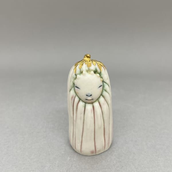 Marina Bauguil tiny sculpture of a plant spirit with a gold flower on its head.