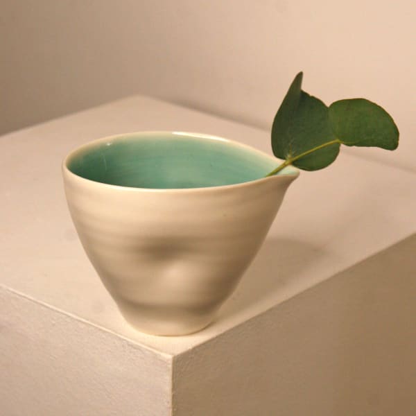 Linda Bloomfield ceramic pouring cup with a turquoise and white glaze