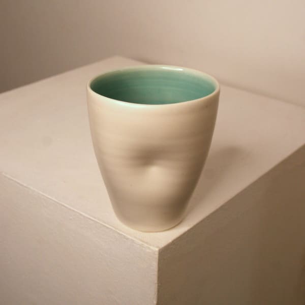 Linda Bloomfield ceramic cup in white and turquoise glaze with a dimple in the centre