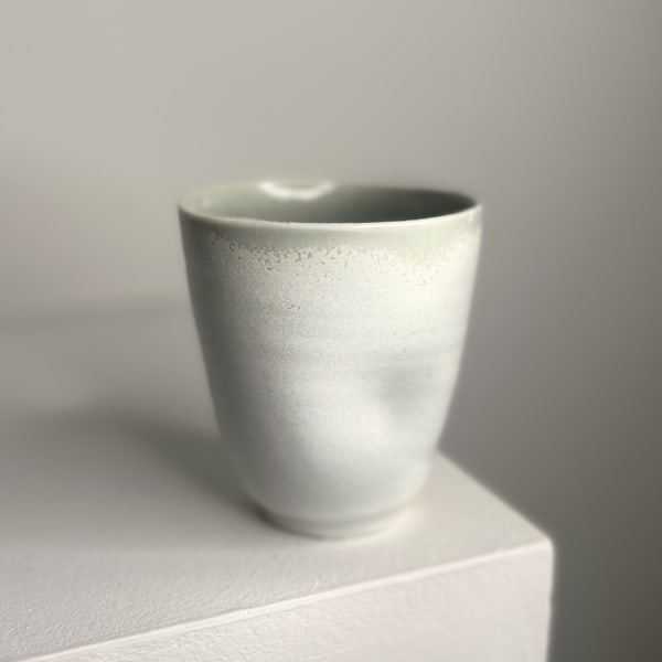Linda Bloomfield ceramic cup with dimples in the centre with white and duck eg blue glaze