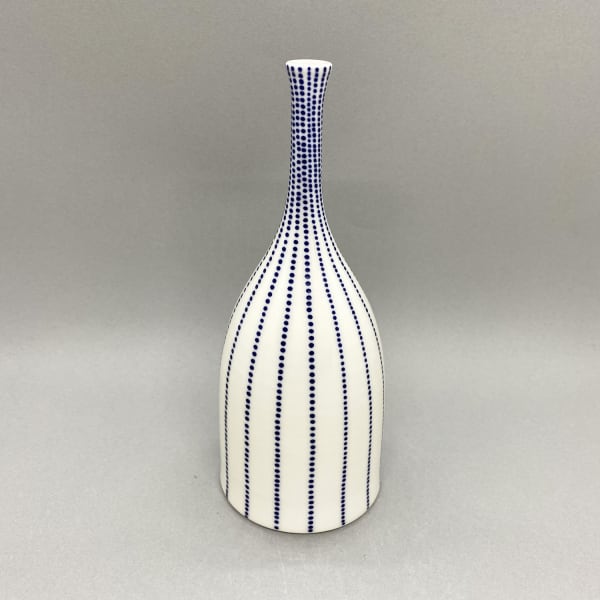 Rhian Malin medium white straight sided Bottle vase with dotty design in blue.