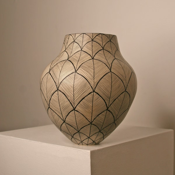 Ant & Di Edmonds of Tydd Pottery small ceramic vessel with an egg shaped oval body and hand painted ginko leaf pattern