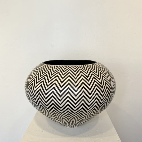 Ant & Di Edmonds - Tydd Pottery wide, heart shaped ceramic black and white vessel with a vertical zig zag pattern. wide, round ceramic pot decorated with a black and white horizontal zig-zag pattern.
