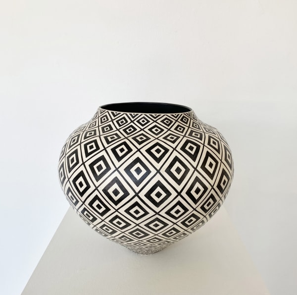 Ant & Di Edmonds - Tydd Pottery wide, round ceramic black and white vessel with a complex diamond pattern with diagonal lines intersecting them.