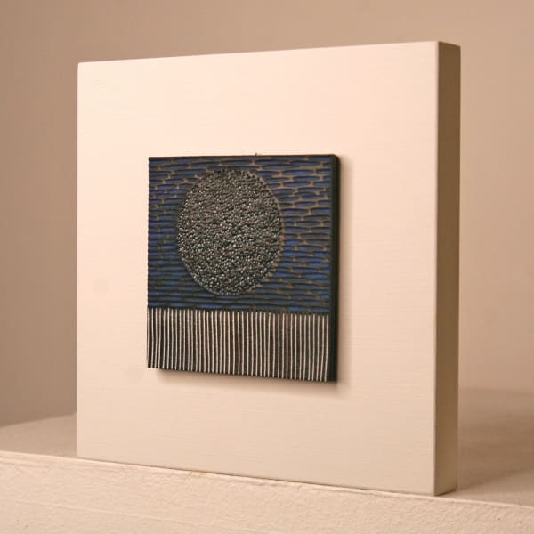 Janine Partington wooden panel with Carved leather design of a moon landscape