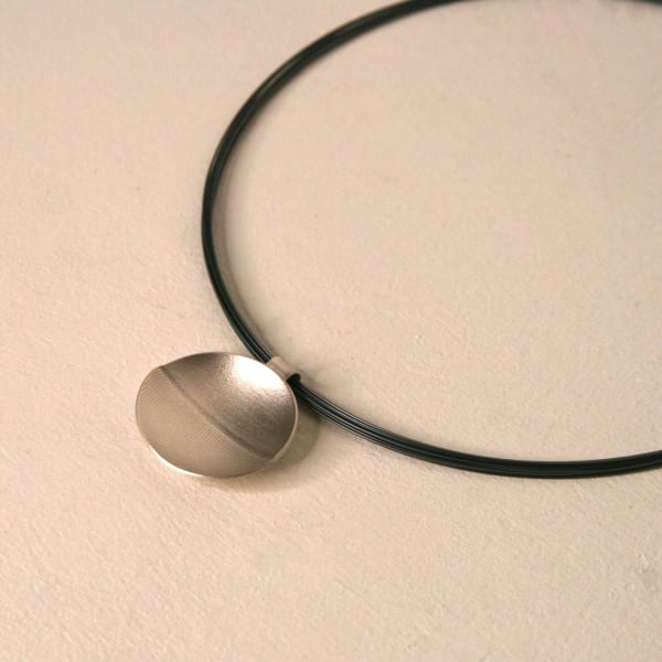 Kate Wilkinson jewellery circular pendant on a stainless steel cable necklace