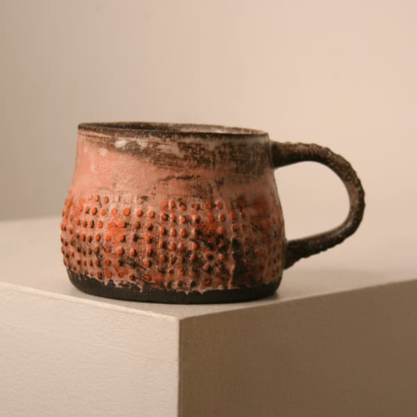 Elly Wall stoneware ceramic mug with raised bumped texture and orange glaze