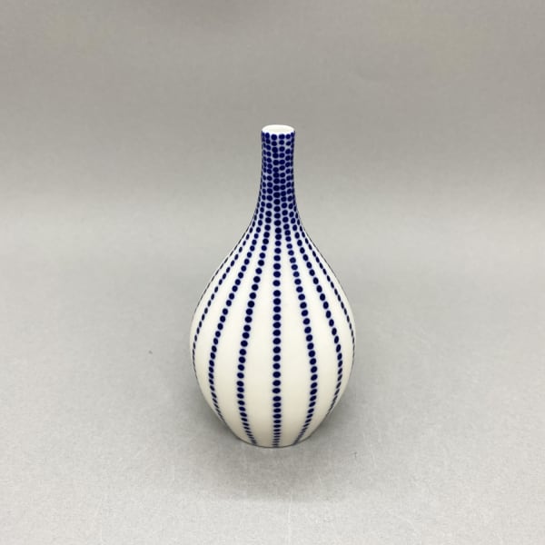 Rhian Malin Small white bottle vase with dotty stripes.