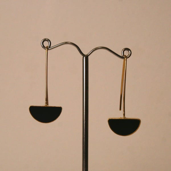 Claire Lowe Jewellery drop style earrings in gold vermeil black resin with semi-circular pendant at the bottom