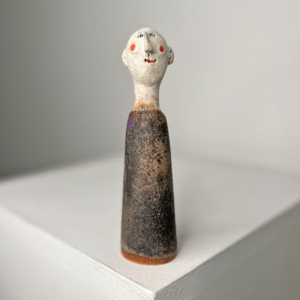 Jane Muir little man ceramic sculpture with textured grey glaze and purple spot