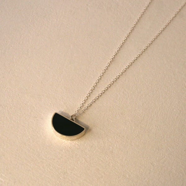 Claire Lowe jewellery silver necklace with silver chain and silver and black resin semi-circular pendant