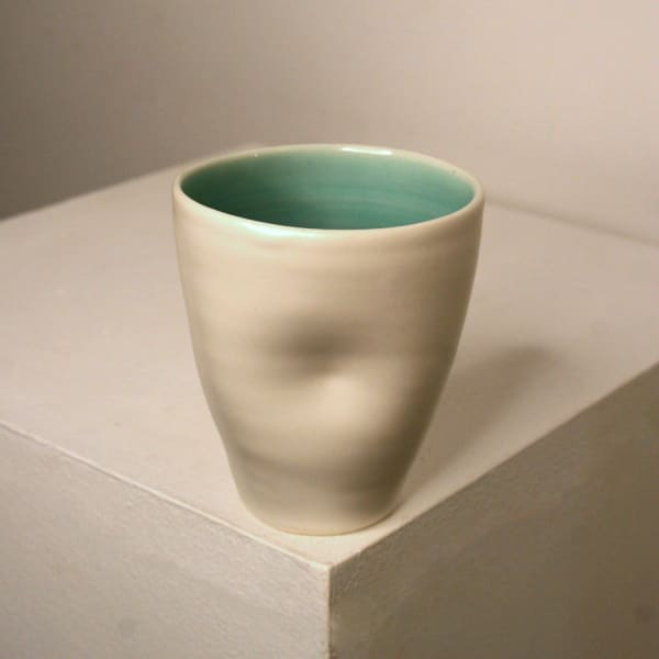 Linda Bloomfield ceramic cup with blue and turquoise glaze with a dimple in the centre