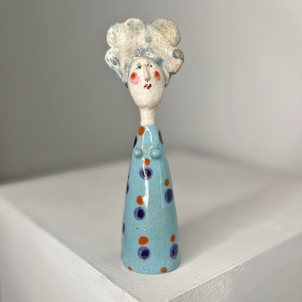 Jane Muir ceramic sculpture on little lady with pale blue glaze and navy and orange dots