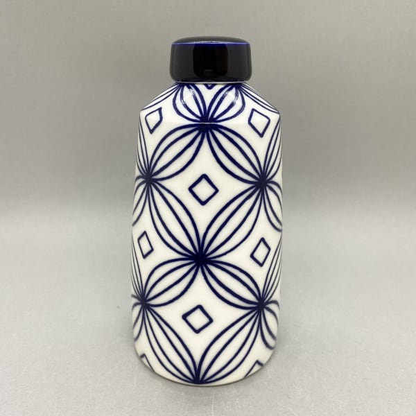 Rhian Malin medium white straight sided ginger jar with flower design in blue with a solid blue lid.