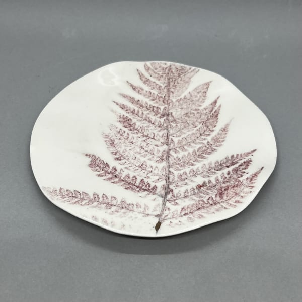 Fliff Carr ceramic plate in white with a detail from a fern leaf printed in maroon.