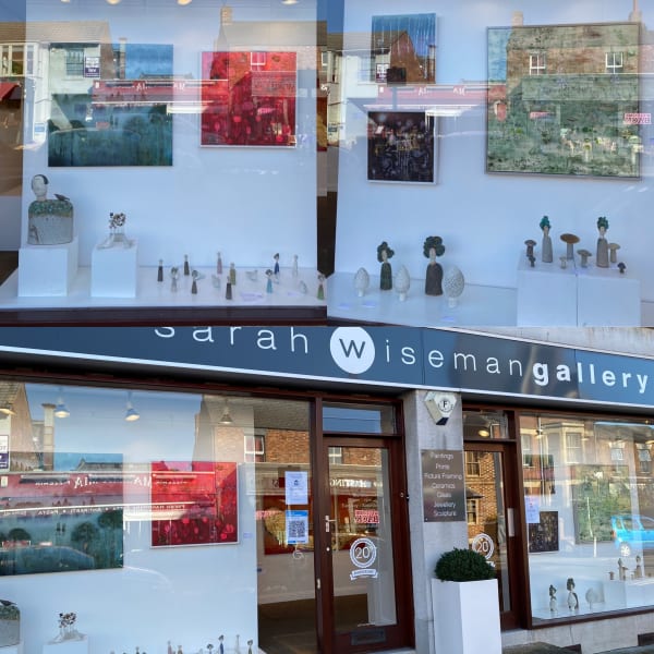 Sarah Wiseman gallery photos in a collage of three - the top two showing each window display and the bottom showing the whole front of the building.