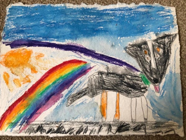 A child's drawing of a dog in a colourful superhero cape with a rainbow