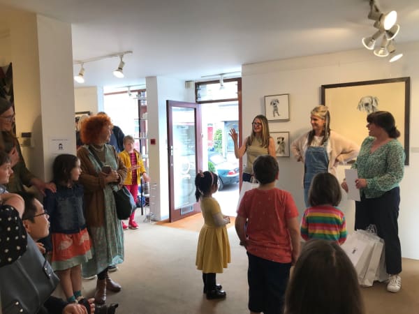 A photograph of Sarah Wiseman Gallery interior, as Sarah Wiseman announces winners of a children's art competition