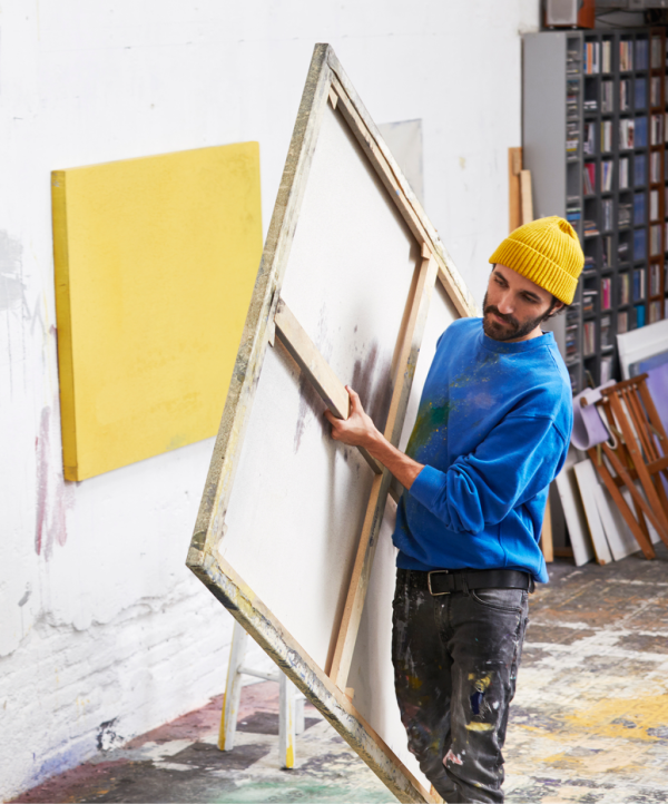 Artist carrying canvas