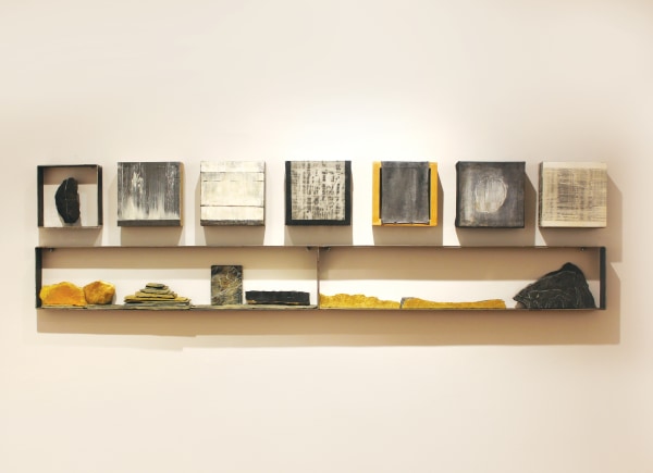 Horizontal Installation, 2018. Stones with gold leaf and yellow resin and oil on canvas, each painting: 8 x 8 in.; 18 x 71 in. overall.