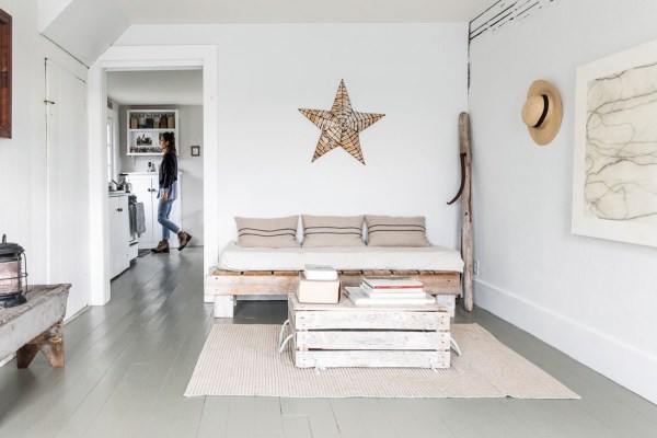 Pulsing lines in Eby’s Boulder Study subtly repeat throughout the modest living room, furnished with seating and a table Bartlett made from sea detritus and one of a pair of antique metal stars — the other is in their Georgia home. The log roller, recovered from the island’s demolished barn, appears in Bartlett’s work, as does his hat.