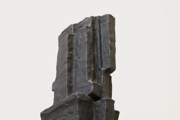 Detail of a bronze sculpture of an abstract form.