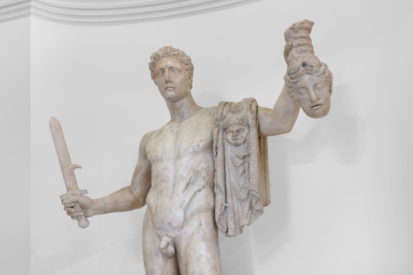 A Pentelic marble sculpture depicting the mythological story of Perseus beheading Medusa.