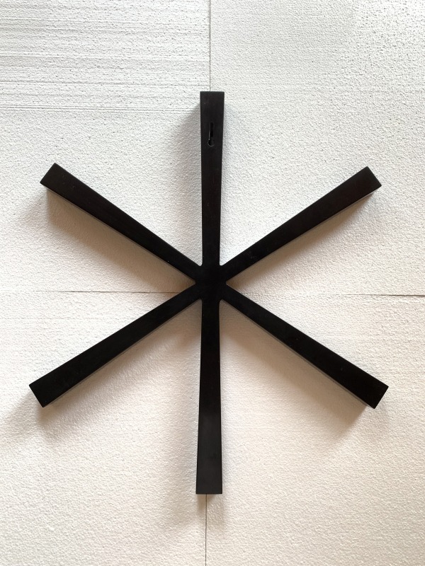 An Ink casting star-shaped wall sculpture.