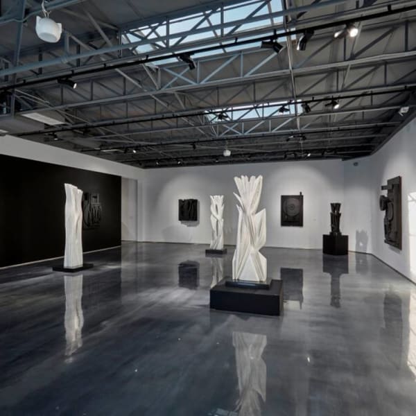 At Atchugarry Art Center, “Dialogue in Black and White” juxtaposes black wood sculptures by Louise Nevelson and white marble sculptures by Pablo Atchugarry through March 30, 2020.