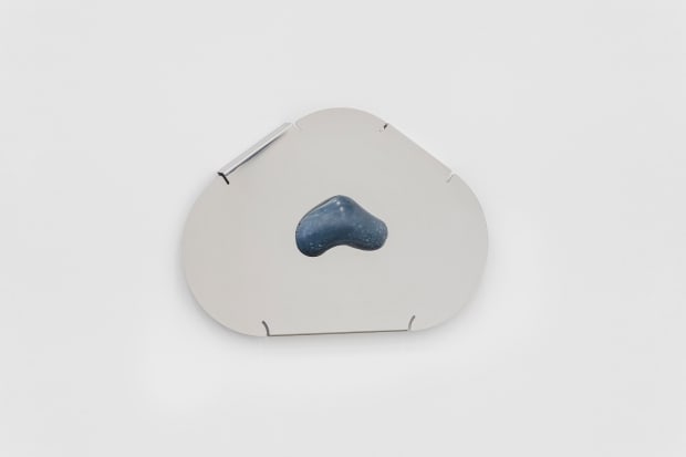 Blocks of contrasting material drape and wrap themselves around each other; metal in a seductive embrace of pigmented concrete, concrete...