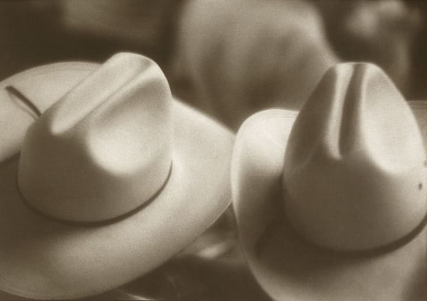 'Seated in the row in front of me at a cattle auction in Texas were these two ranchers. I was...