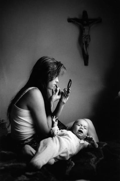 Rosario y Boo Boo is an intimate portrait that captures a moment of everyday life, blending femininity, motherhood, and spirituality....