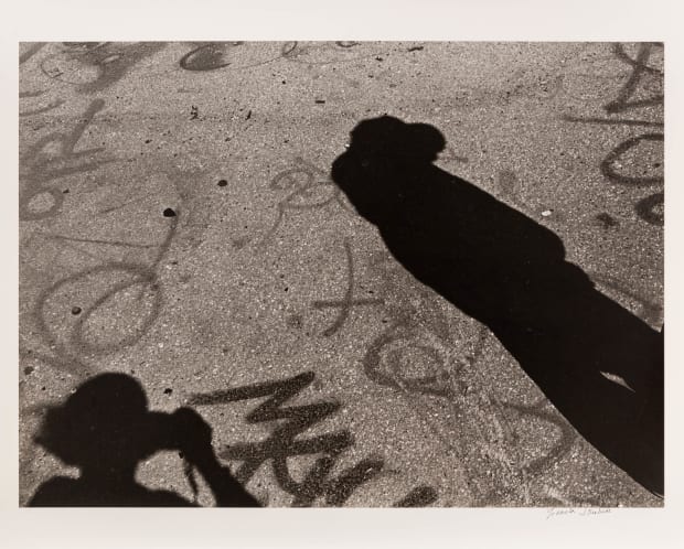 Autorretrato en sombra serves as a self-portrait in which Graciela Iturbide captures her own shadow holding the camera, cast upon...