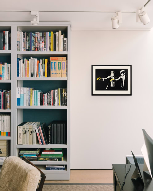Image of bookcase in Andipa gallery with Banksy's Pulp Fiction print