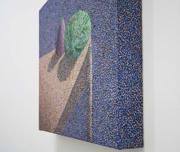 Pointillist depiction of a green cabbage and purple eggplant sitting on the edge of a wood table