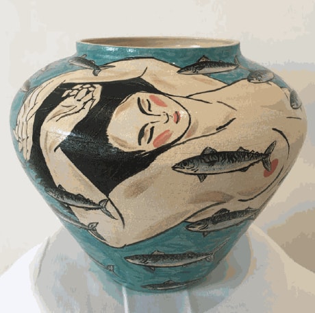 Figure swims on a bright blue vase surrounded by mackerel. The vase shows a feeling of being swept along with...
