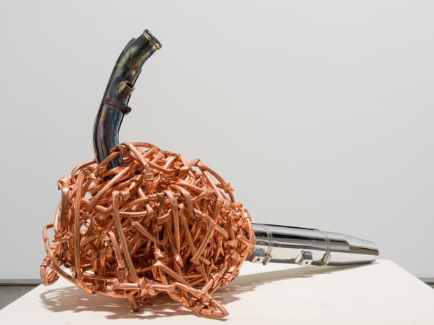 In Weaving (2016), an exhaust pipe intended use is trapped into a ball of copper tubes weaved ad knotted together....