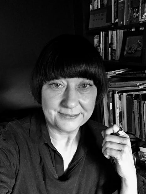 Black and white photograph of the British artist Lisa Ivory in her studio.